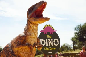 A roaring dinosaur outside the Dino Dig zone